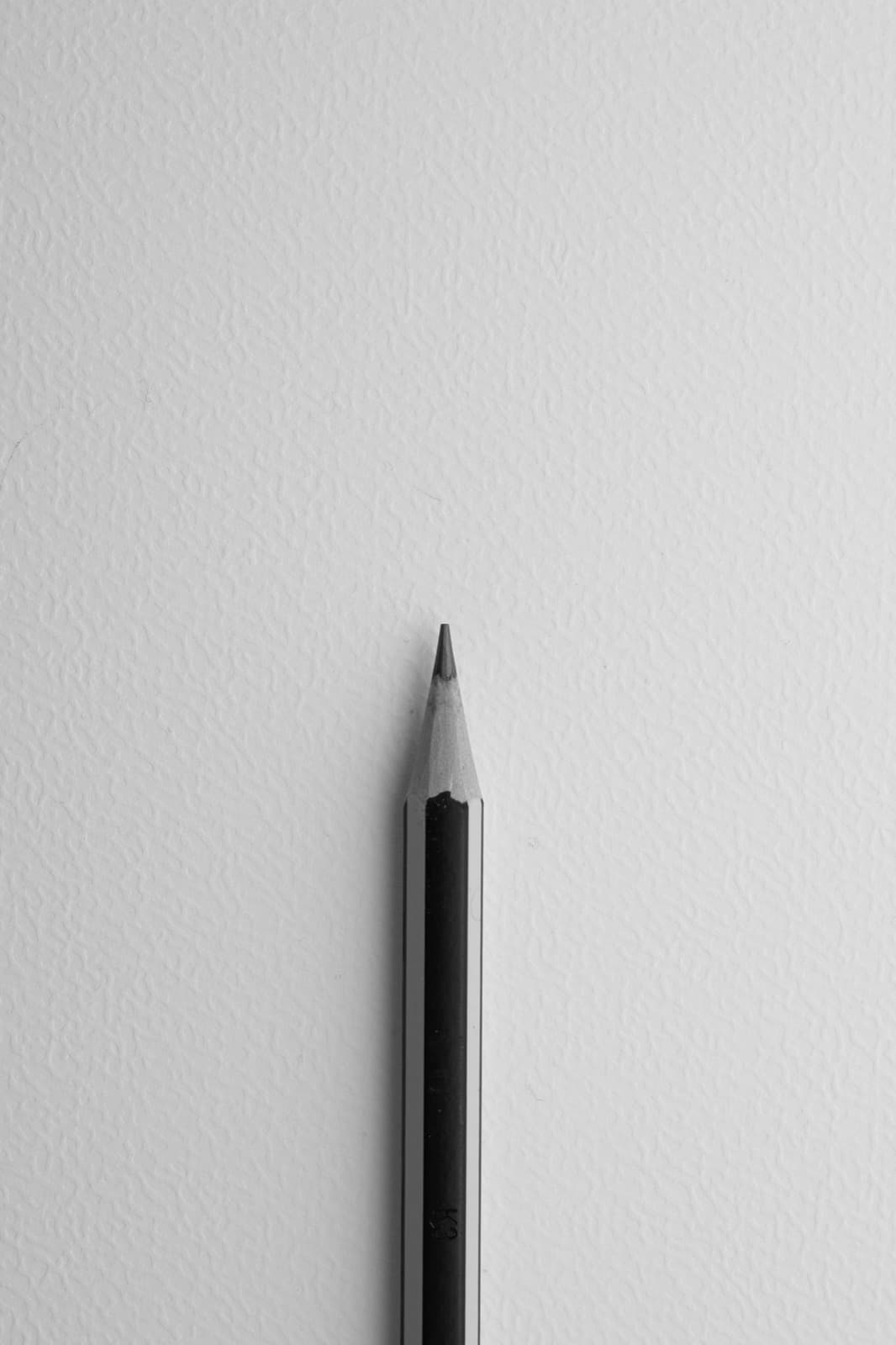Pencil against paper wall